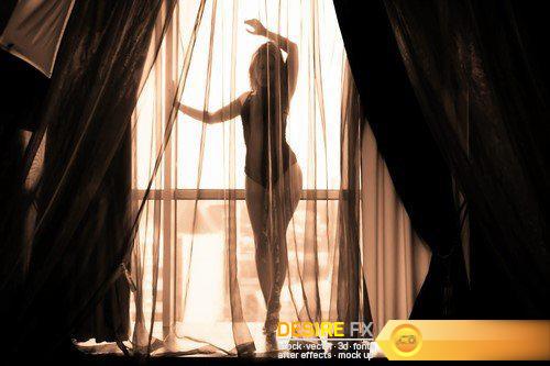 Beautiful young woman on a light background window 15X JPEG