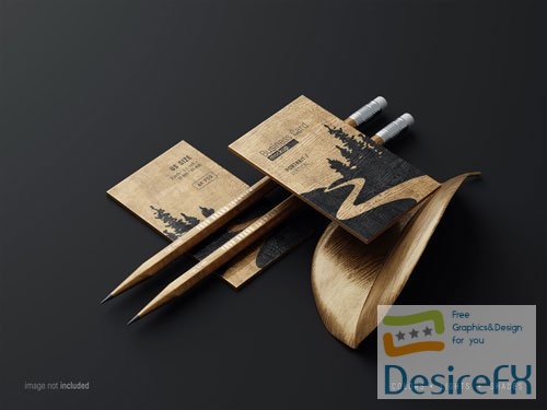 PSD wooden business card mockup scene with pencils and fancy leaf